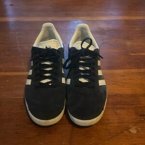 Navy blue Adidas Gazelle shoes.